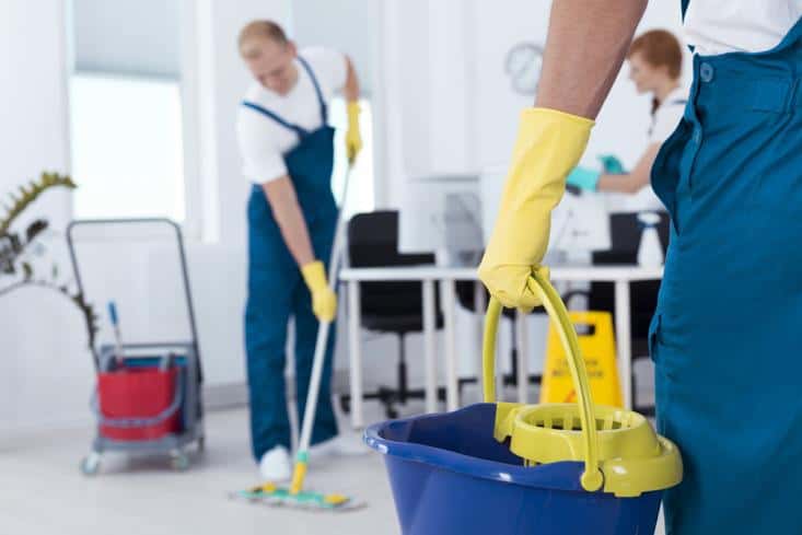 Three house cleaners on the job cleaning the house