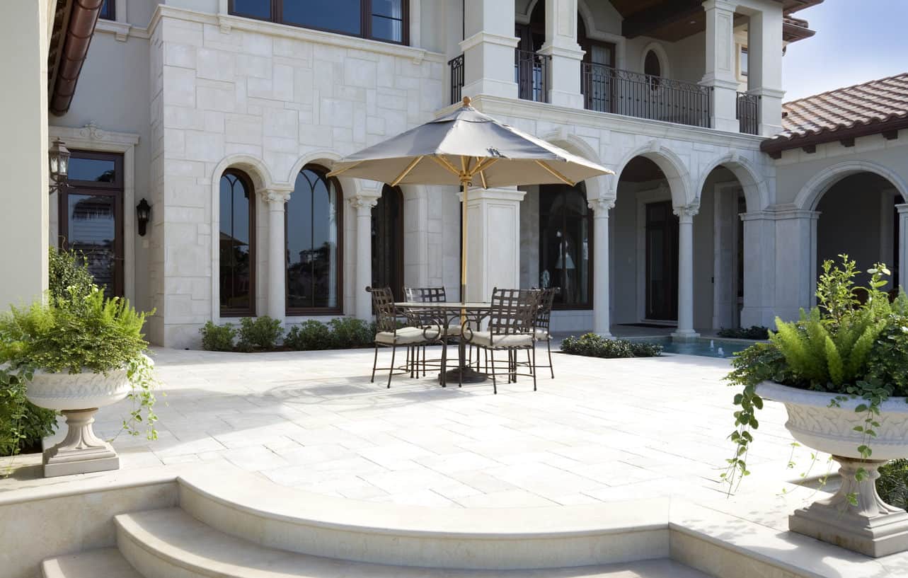 Luxury patio with patio furniture on flagstone flooring.