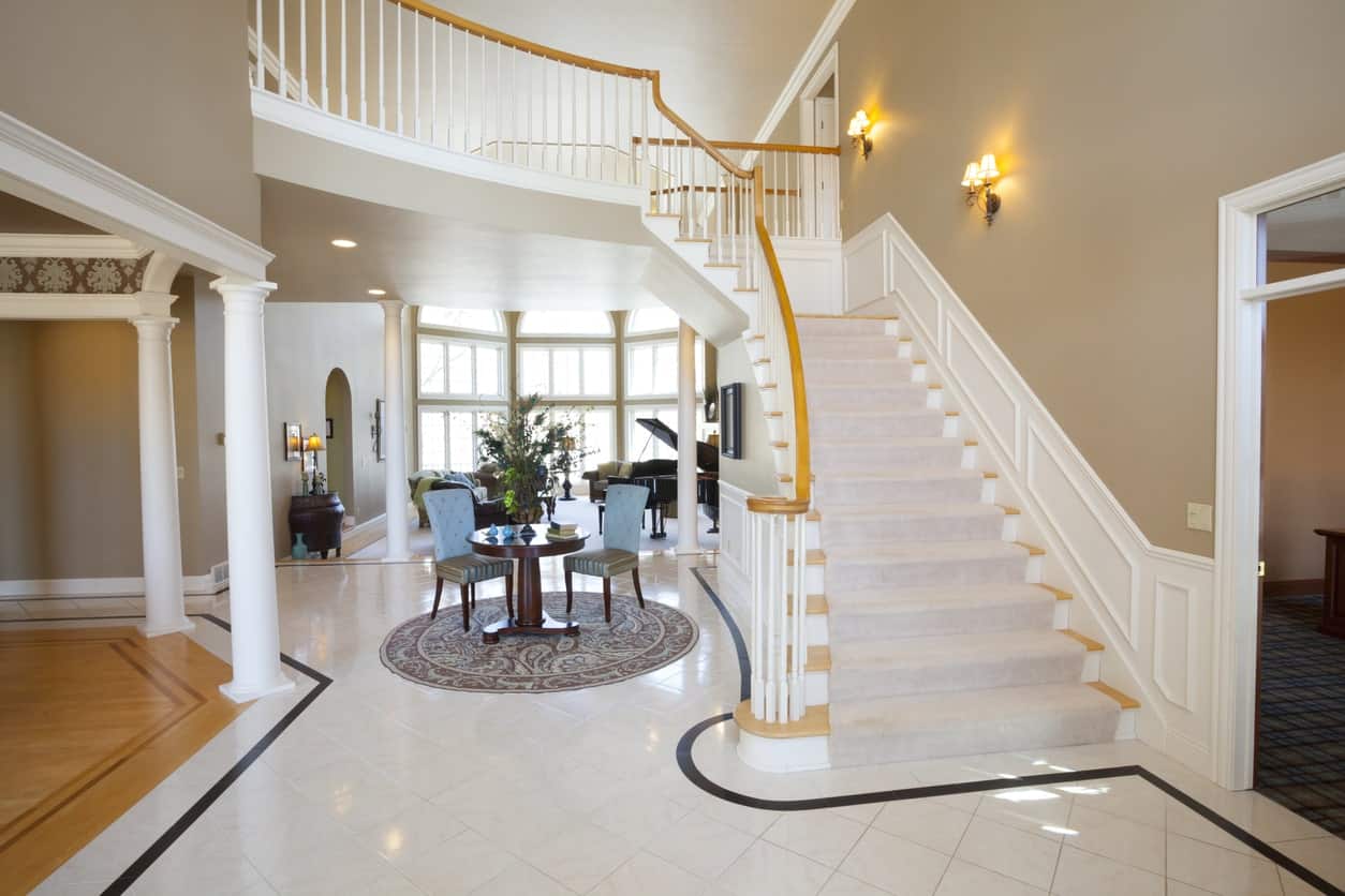 White large foyer with gold shade. The wall lighting adds style to the glamorous foyer.