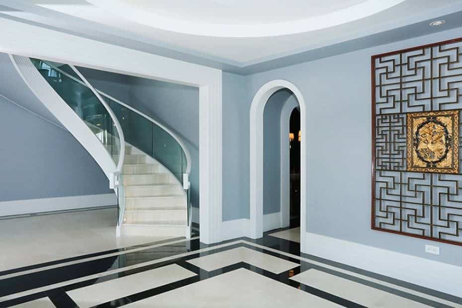 Another look of this large modern foyer featuring a stylish flooring, walls and staircase.