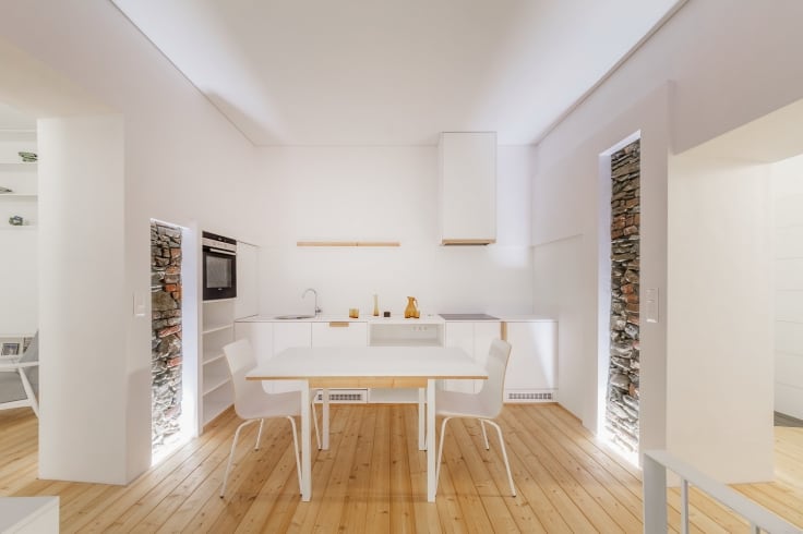 An interior shot of a modern white theme dining area with a touch of a vintage design.