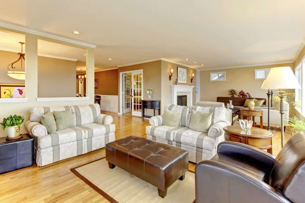 Large living room with stylish seats and romantic warm white lights all over the place.