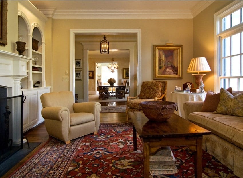 An elegant living room featuring a glamorous set of seats on top of a lovely rug.