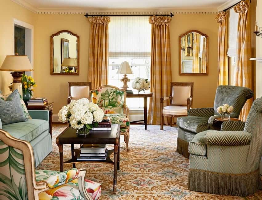 This living room is surrounded by elegant furniture sets along with hardwood flooring and window curtains.