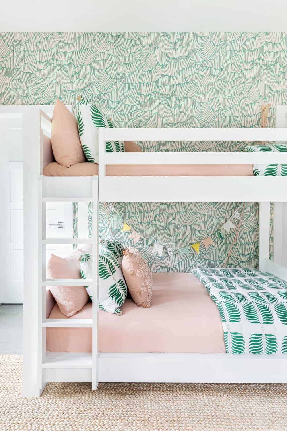 A close up look at the kids' bunk bed featuring a white, beige and green color scheme.