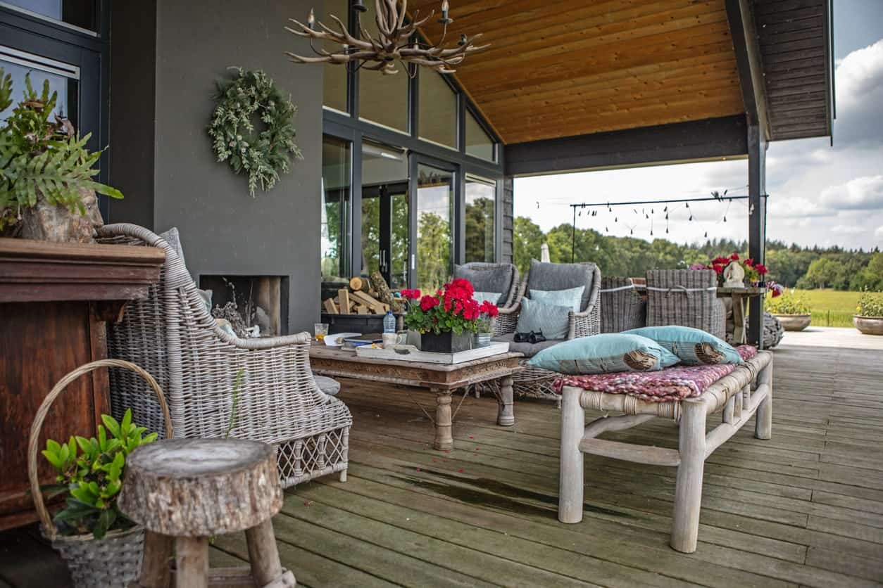 Large deck featuring an outdoor sofa set near the fireplace.