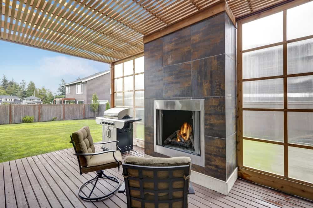 This deck boasts modern seats in front of a stylish fireplace.