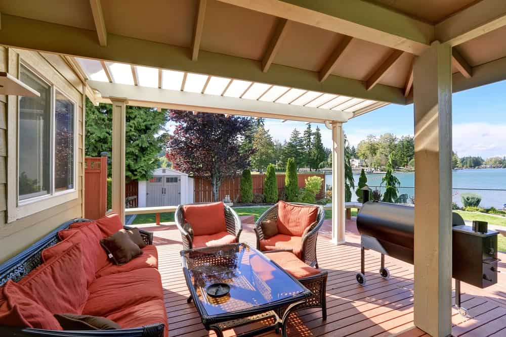 Covered deck featuring a cozy set of seats overlooking the beautiful river surrounding the area.