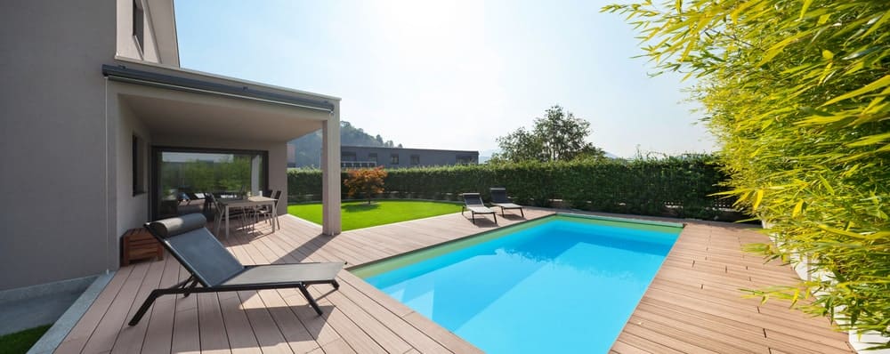 This large deck with lounger seats surrounds the swimming pool.