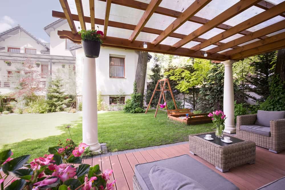 This deck is set on the garden's corner. The rattan furniture with cushion seats and foam backrests look stunning.