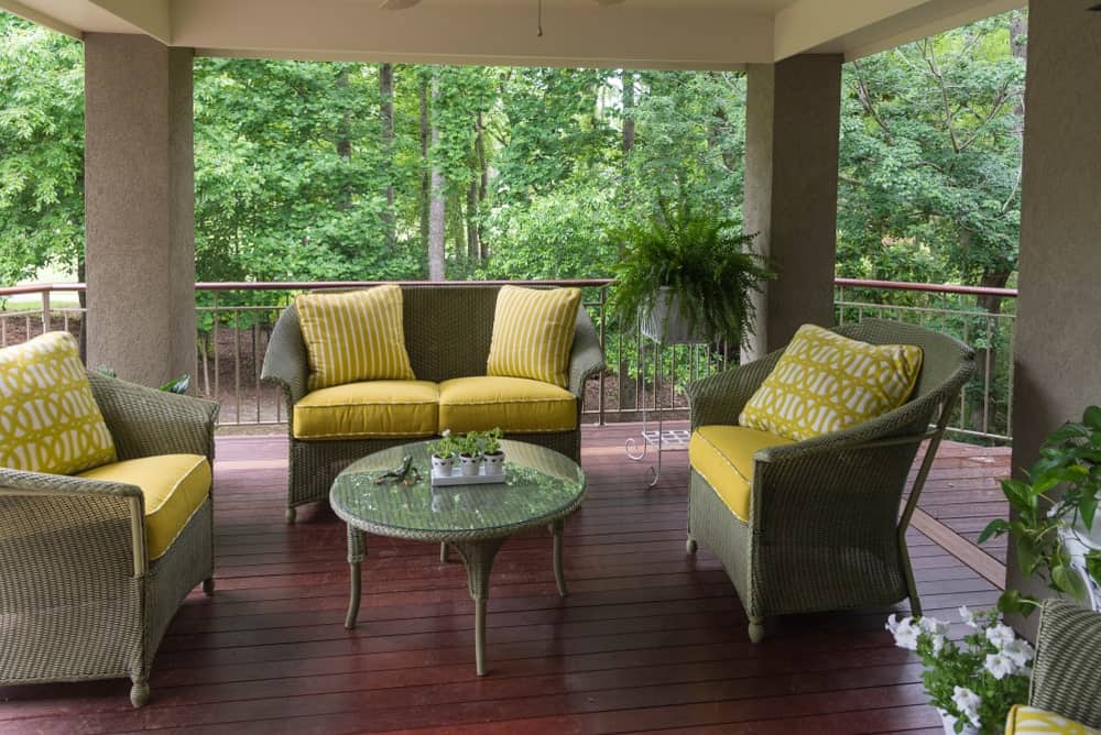 This deck offers rattan seats and center table set on the rustic flooring.