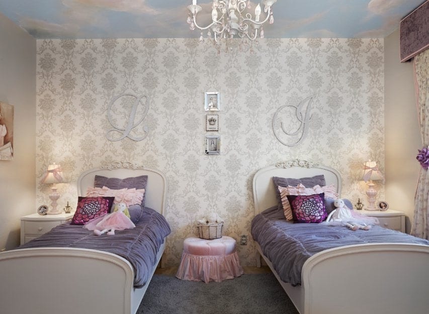 This girls bedroom offers a twin bed with a lovely rug and side tables along with an elegant wall with classy decors.