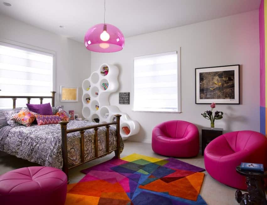 This girl's bedroom boasts interesting room designs and seats, along with the colorful rug. The bed looks very classy as well.