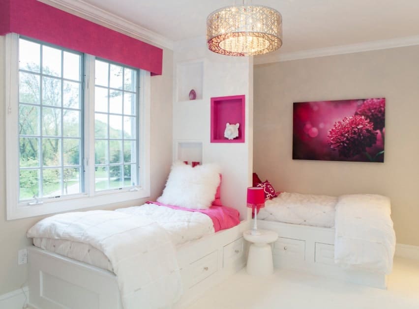 This girls bedroom features lovely beds that are perfectly placed, together with stunning wall decor. The pink shade adds class to the girls' room.