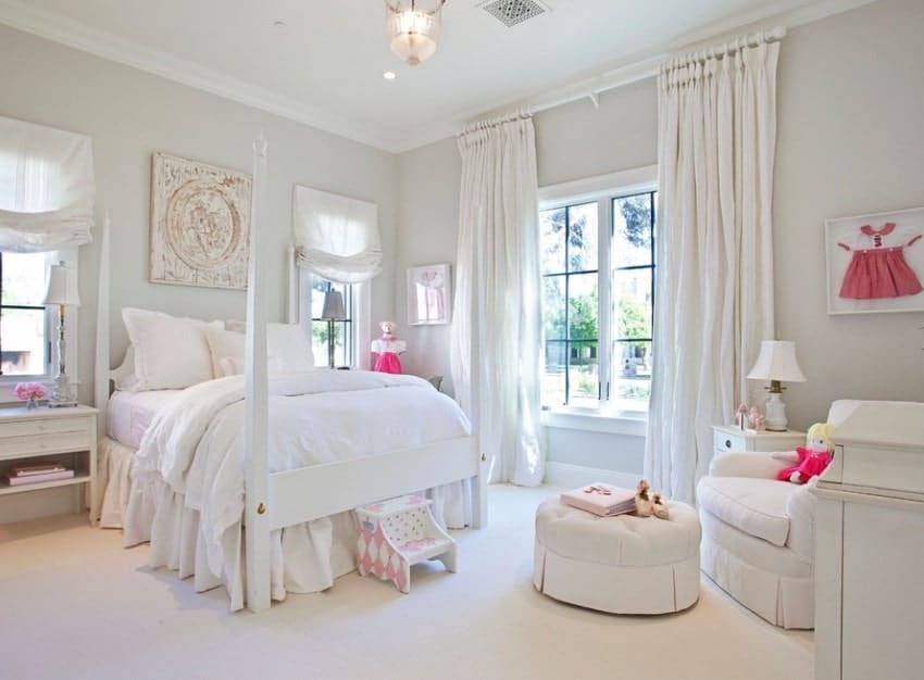 This girl's bedroom offers a white bed, matching with the white carpet flooring, white walls and white window curtains. The other furniture in the room are finished with white as well.