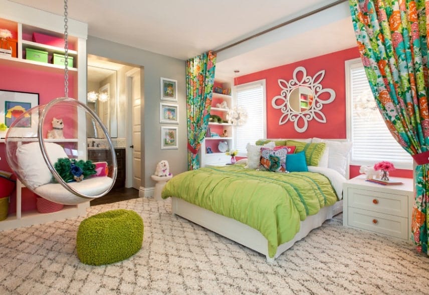 Large girl's bedroom with carpet flooring and lovely curtains. There's a swing made of glass, adding style to the bedroom.