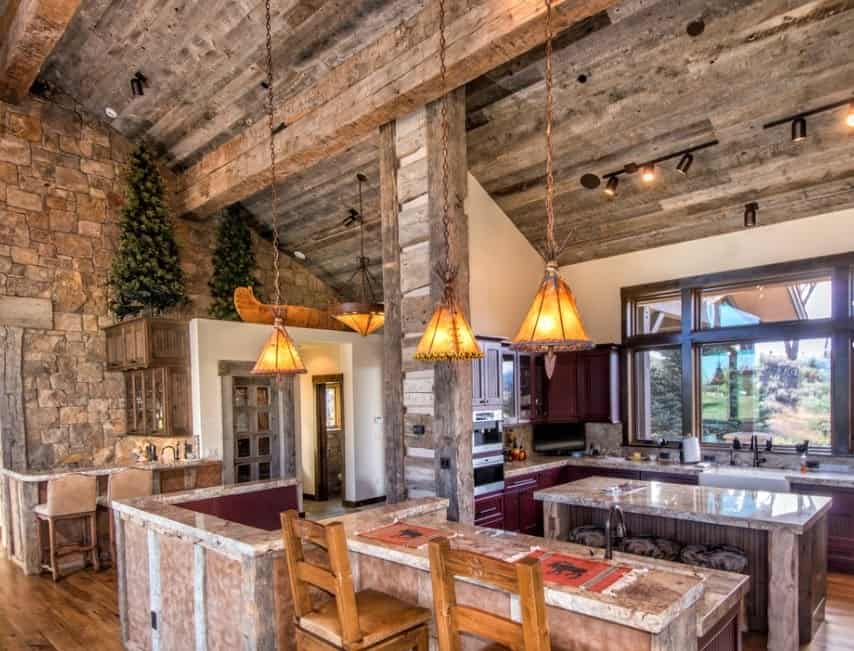 Classy rustic kitchen with shed ceiling lighted by pendant and track lights. The counters and center island offer vintage feels.