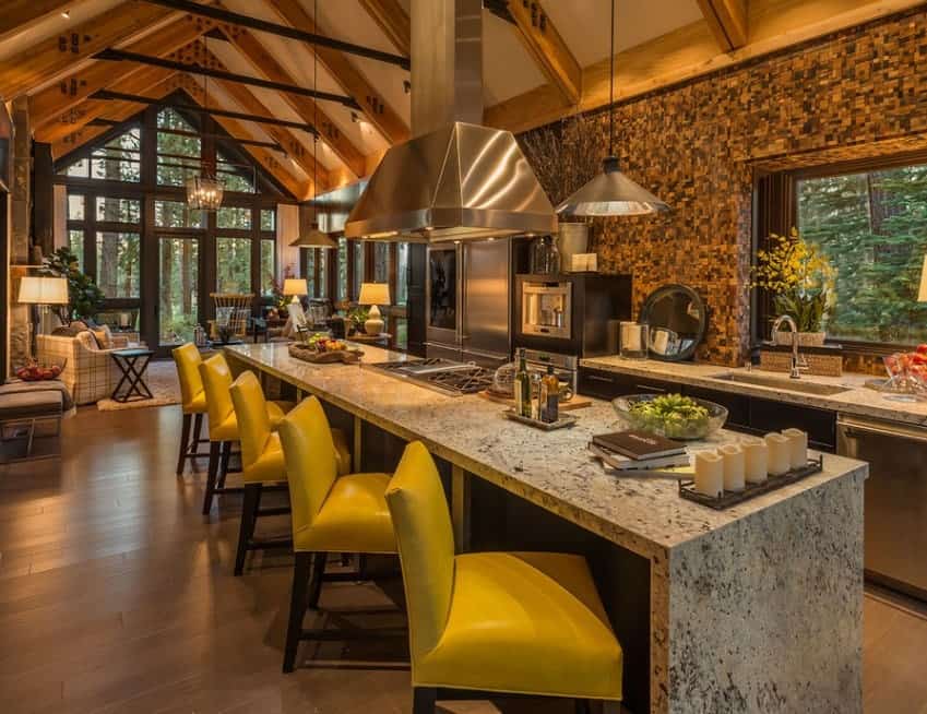 Beautiful kitchen set with long vaulted ceiling with rustic rafters. The wall looks stunning while the lighting is just perfect together with the kitchen's style.