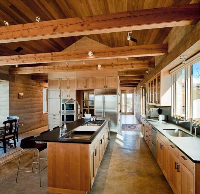 This kitchen features rustic finish all over the place. The countertops on both counters and center island are finished with dark paint for additional style.