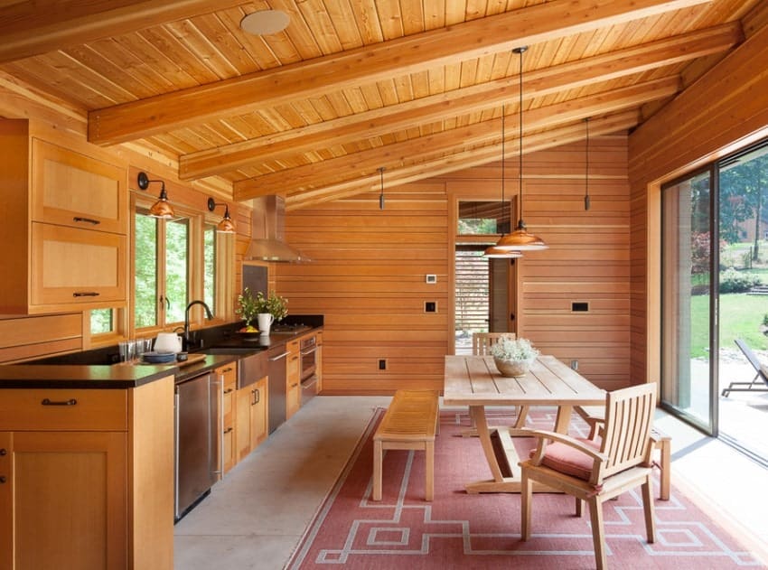 This kitchen area surrounded by cherry-finished walls, ceiling, cabinetry and kitchen counter looks absolutely lovely.