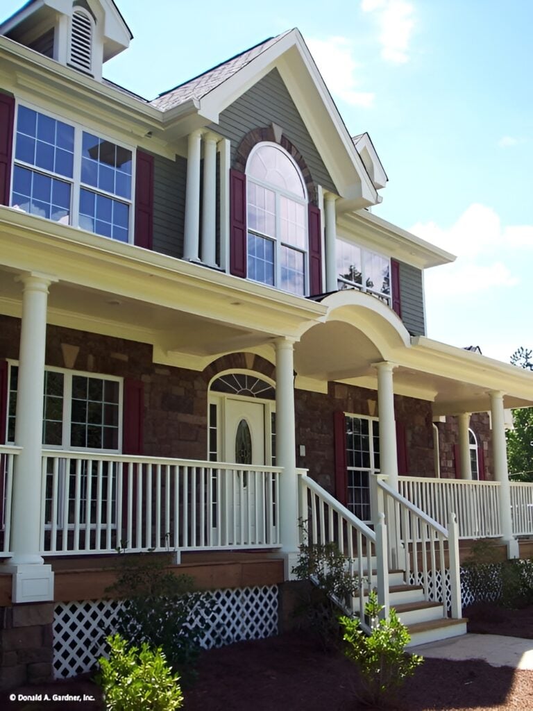 The front porch has an arched entryway complemented with a stoop.