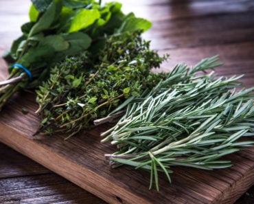 Several herbs on cutting board