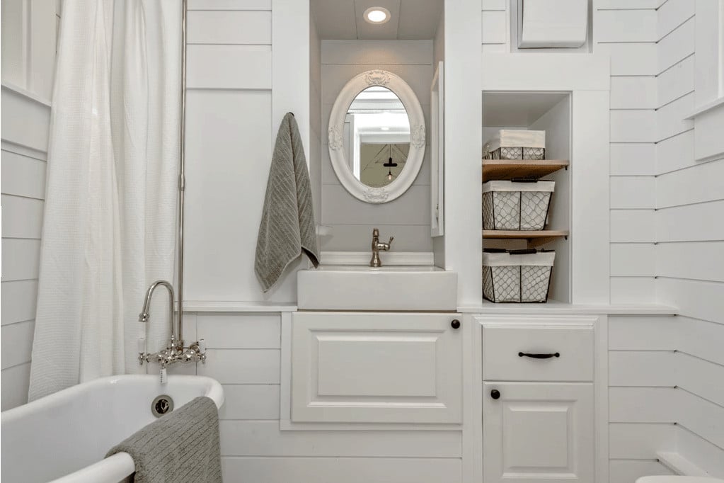 Notice the clever sink design how it's built into a wall of bathroom storage cabinets.