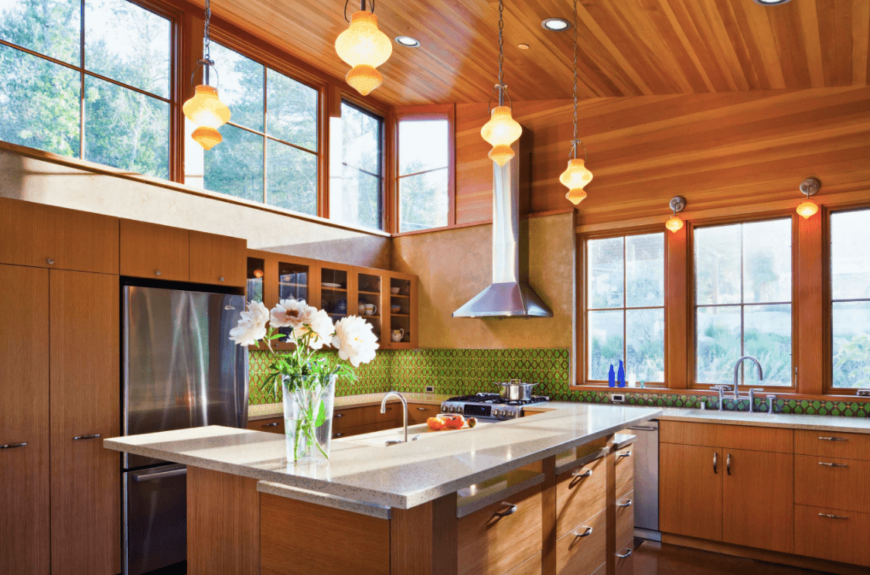 A classy kitchen featuring a high shed ceiling finished with cherry accent pairing perfectly with the walls and floors.