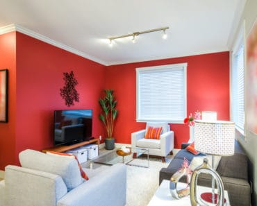 living room with red accent wall