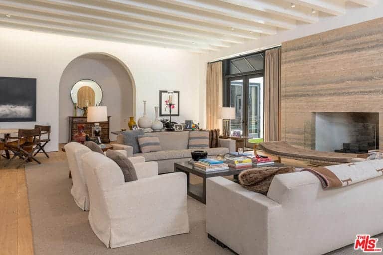 Brown and gray sofas with skirted chairs and wooden coffee table filled this formal living room.