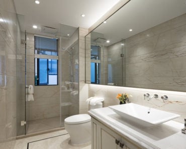 Photo of a modern bathroom with toilet, basin, vanity and shower