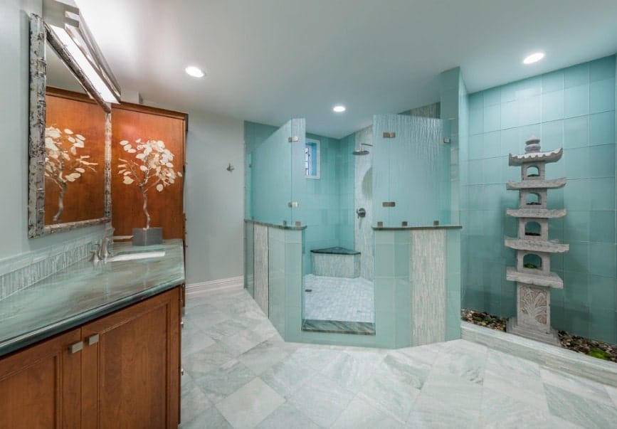 Green Asian-style primary bathroom featuring a single sink counter, a large walk-in shower and a very attractive stone decoration.