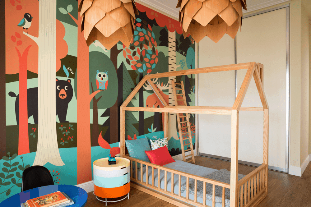 Kids bedroom designed with a wildlife mural and a pair of pine cone pendants that hung over the custom bed matching with the wooden ladder. 