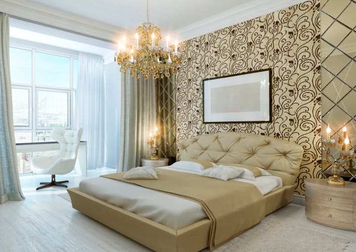 A focused shot at this primary bedroom elegantly-designed wall along with a luxurious bed lighted by a glamorous chandelier.