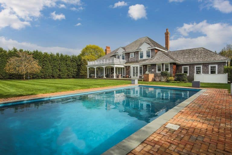 This home offers a large peaceful backyard with well-maintained lawn area along with a rectangular swimming pool on the side.