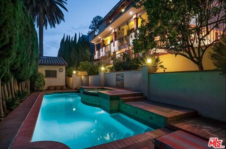 This home offers a deck area surrounding the swimming pool. The home has lots of healthy mature trees surrounding the property.