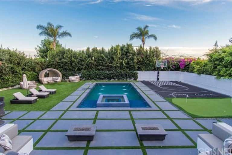 Large outdoor area featuring a half-court basketball court along with a lawn area with lovely seats and a custom-made swimming pool.