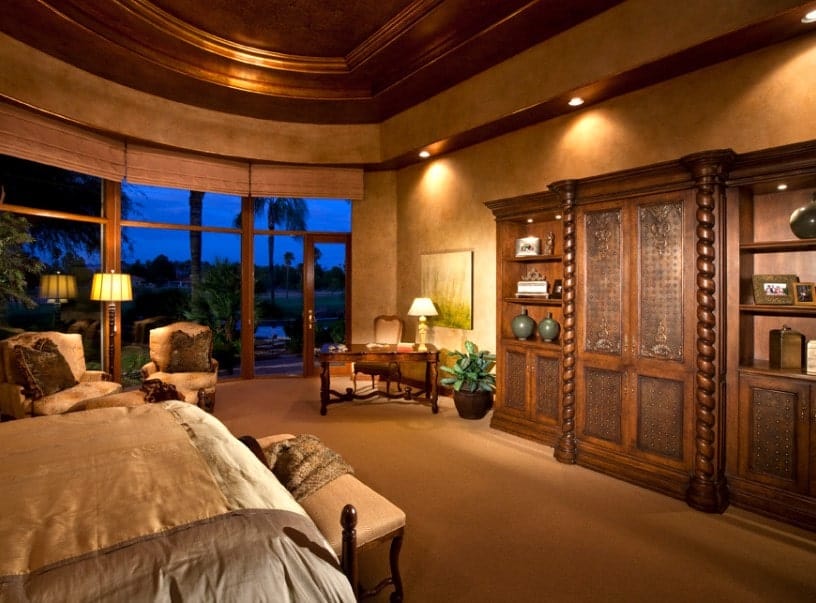 Primary bedroom featuring brown walls and brown carpet flooring, along with a stunning brown ceiling. The room also offers a large comfy bed.
