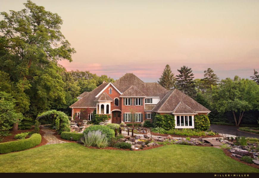 From this vantage point, you can fully appreciate the entirety of the aesthetic created by the Country-style landscaping. This front of the home has a man made stream decorated with various rocks and crossed by a small wooden bridge.