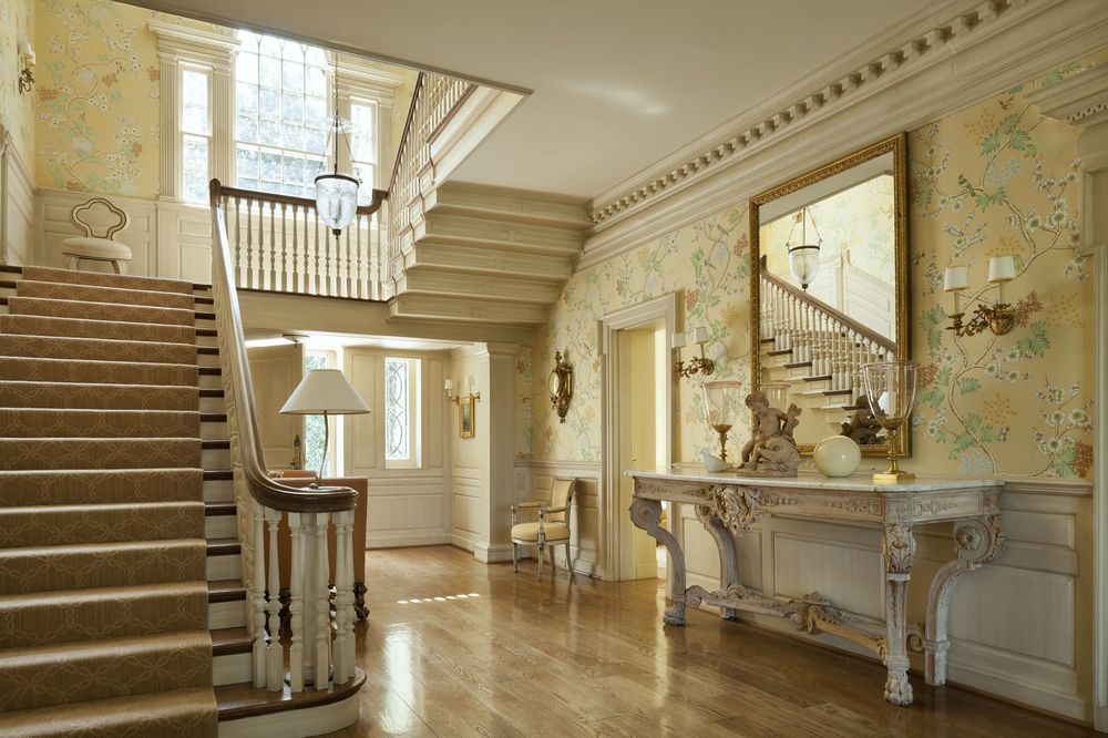 Upon entry of the house, you are welcomed by this charming foyer with elegant beige walls that match the console table on the side topped with a large mirror.