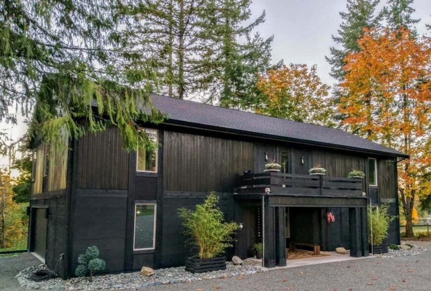 The home is guarded by fresh plants and towering trees for optimum privacy.