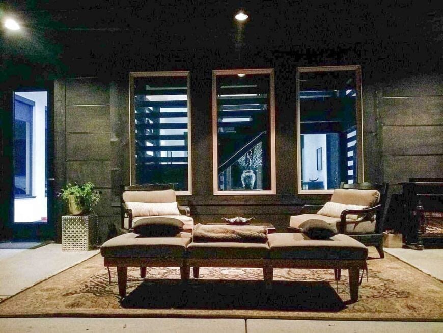 A farther view shows the sectional bench and three glazed windows overlooking the living room and stairwell.