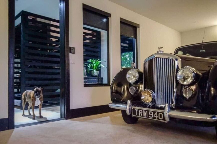 From the foyer is another three-car garage with a vintage luxury car.