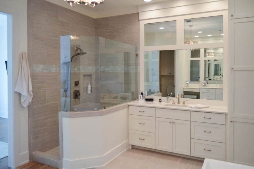 The primary bathroom offers a walk-in shower and a white sink vanity paired with a large mirror.