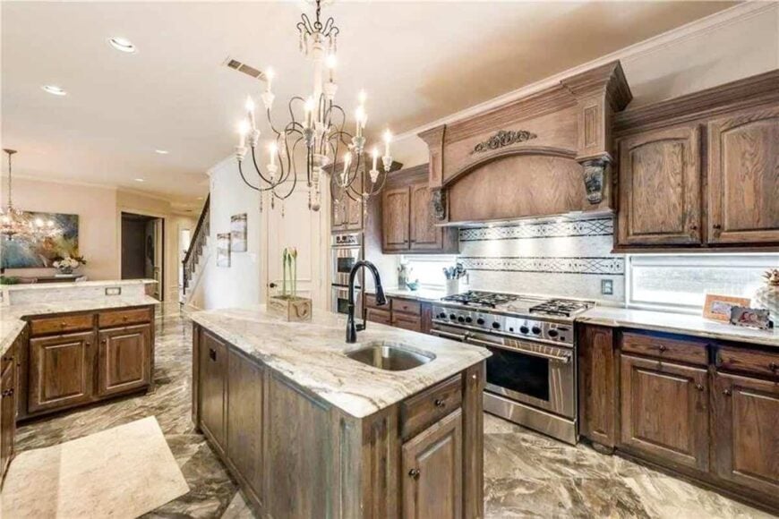 The opposite side view shows the cooking alcove and another sink fitted on the center island bar.