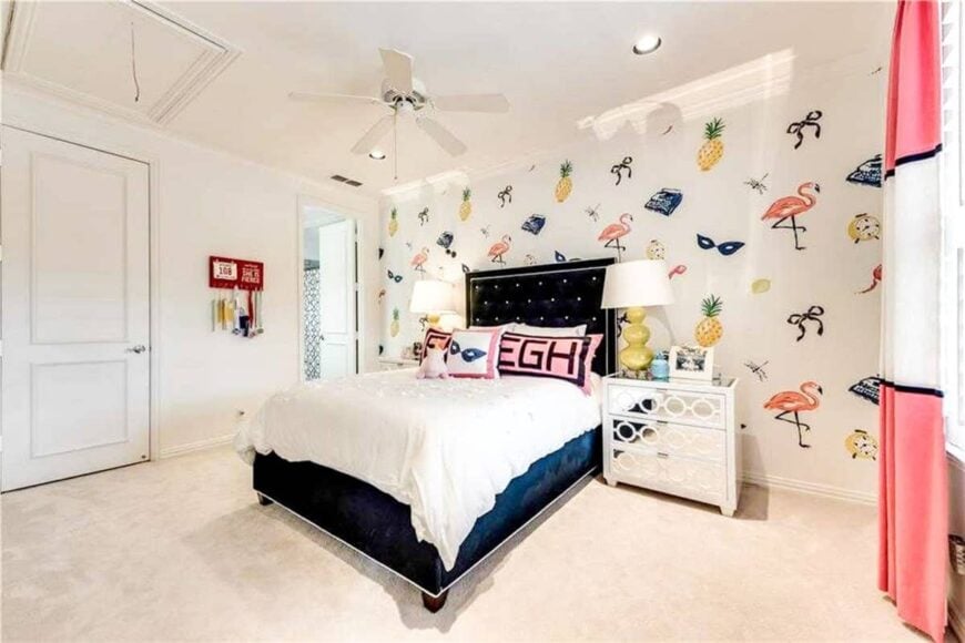 A cool patterned wallpaper sets a fun backdrop to the black tufted bed and mirrored nightstands in this kid's bedroom.