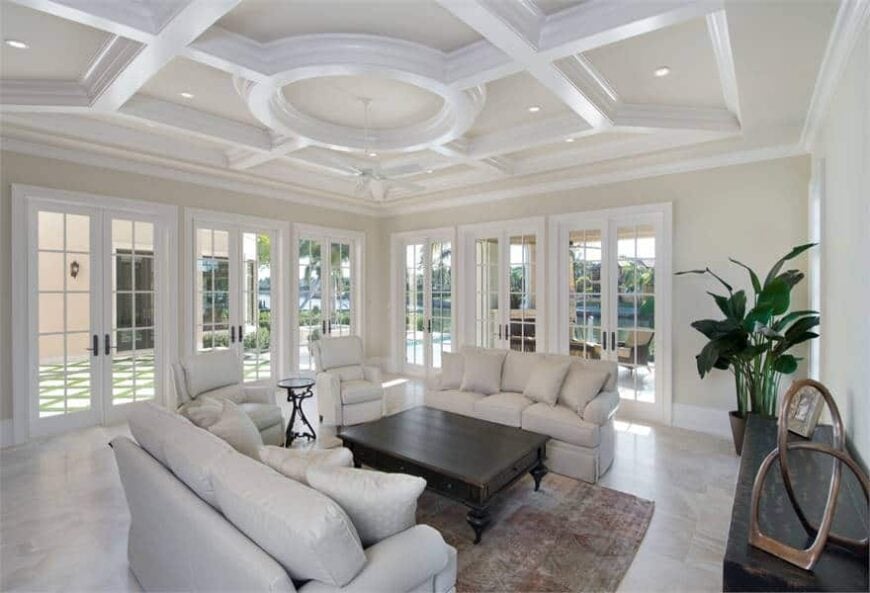 Family room with stunning tray ceiling and surrounding french doors leading out to the covered lanai.