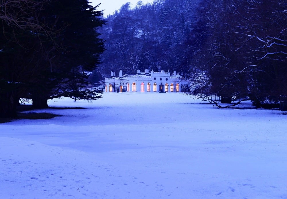 Stunning outside view of the Guinness Beer Castle in Dublin, Ireland. The grounds are covered in snow.