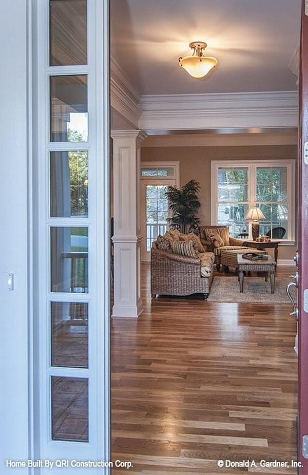 The front door opens to the foyer and the living room beyond.