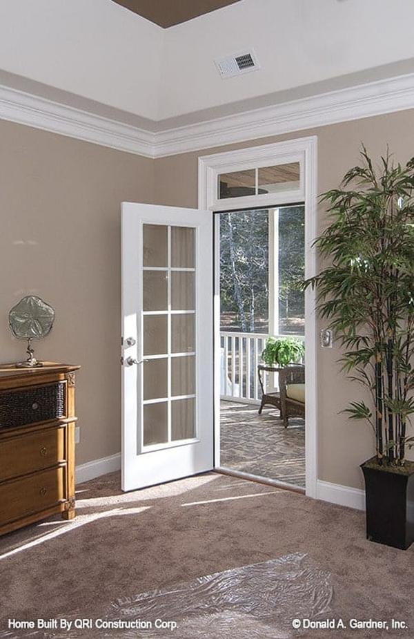 Bedroom's white framed door leading to the screened porch.